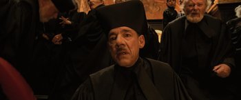 Movie still from “Harry Potter and the Goblet of Fire” (2005), directed by Mike Newell – A man wearing a black hat and a black robe; Close Up shot, Low angle