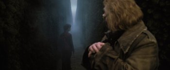 Movie still from “Harry Potter and the Goblet of Fire” (2005), directed by Mike Newell – Two people are standing in a dark forest; Medium shot, Over the shoulder angle