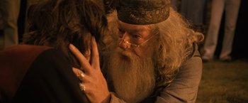 Movie still from “Harry Potter and the Goblet of Fire” (2005), directed by Mike Newell – A man with long white hair and a beard wearing glasses; Close Up shot, Over the shoulder angle