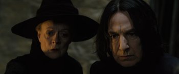 Movie still from “Harry Potter and the Goblet of Fire” (2005), directed by Mike Newell – Two people in black shirts and a black hat; Close Up shot, Low angle