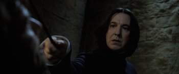 Movie still from “Harry Potter and the Goblet of Fire” (2005), directed by Mike Newell – A man in black jacket holding a remote control; Close Up shot, Low angle