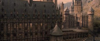 Movie still from “Harry Potter and the Goblet of Fire” (2005), directed by Mike Newell – An old building with a castle like structure on top of it; Extreme Wide shot, High angle