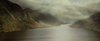 Movie still from “Harry Potter and the Goblet of Fire” (2005), directed by Mike Newell – A body of water surrounded by mountains and a cloudy sky; Extreme Wide shot, High angle