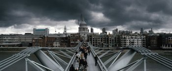Movie still from “Harry Potter and the Half-Blood Prince” (2009), directed by David Yates – People are walking across a bridge on a cloudy day; Extreme Wide shot, High angle