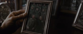 Movie still from “Harry Potter and the Half-Blood Prince” (2009), directed by David Yates – A person holding a picture of a group of people; Close Up shot, High angle