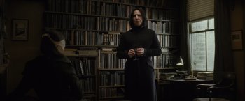 Movie still from “Harry Potter and the Half-Blood Prince” (2009), directed by David Yates – A man standing in front of a book shelf; Medium shot, Low angle