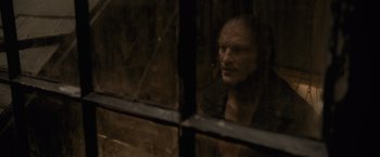 Movie still from “Harry Potter and the Half-Blood Prince” (2009), directed by David Yates – An old man looking out of a window at night; Close Up shot, Over the shoulder angle