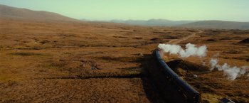 Movie still from “Harry Potter and the Half-Blood Prince” (2009), directed by David Yates – An aerial view of a train on the tracks in the middle of a field; Extreme Wide shot, High angle