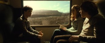 Movie still from “Harry Potter and the Half-Blood Prince” (2009), directed by David Yates – A man and a woman are sitting on a train looking out the window; Medium shot, Over the shoulder angle