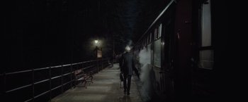 Movie still from “Harry Potter and the Half-Blood Prince” (2009), directed by David Yates – A man walking down a train platform next to a train; Wide shot, Low angle