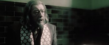 Movie still from “Harry Potter and the Half-Blood Prince” (2009), directed by David Yates – An old man with a beard and a suit; Close Up shot, Over the shoulder angle
