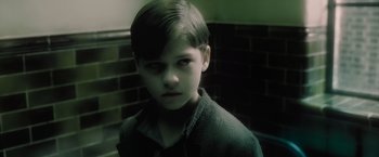 Movie still from “Harry Potter and the Half-Blood Prince” (2009), directed by David Yates – A young boy is looking into the camera; Close Up shot, High angle