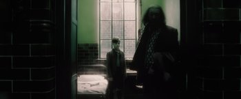 Movie still from “Harry Potter and the Half-Blood Prince” (2009), directed by David Yates – A man and a boy standing in front of a window; Medium shot, Over the shoulder angle