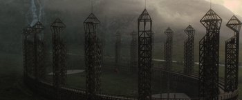 Movie still from “Harry Potter and the Half-Blood Prince” (2009), directed by David Yates – A group of tall metal structures in a field; Extreme Wide shot, High angle