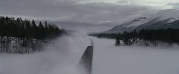Movie still from “Harry Potter and the Half-Blood Prince” (2009), directed by David Yates – A train traveling down tracks through a snow covered forest; Extreme Wide shot, High angle