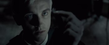 Movie still from “Harry Potter and the Half-Blood Prince” (2009), directed by David Yates – A man's face in the dark; Close Up shot, Low angle