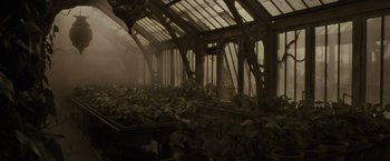 Movie still from “Harry Potter and the Half-Blood Prince” (2009), directed by David Yates – A greenhouse with plants growing inside of it; Wide shot, High angle