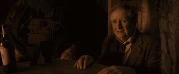 Movie still from “Harry Potter and the Half-Blood Prince” (2009), directed by David Yates – An old man sitting at a table with a woman; Medium shot, High angle