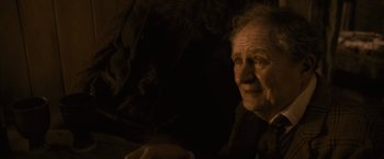 Movie still from “Harry Potter and the Half-Blood Prince” (2009), directed by David Yates – An old woman sitting in a dark room; Close Up shot, Over the shoulder angle