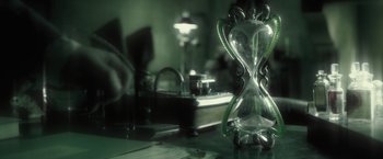 Movie still from “Harry Potter and the Half-Blood Prince” (2009), directed by David Yates – An hourglass sitting on top of a table; Extreme Close Up shot, High angle