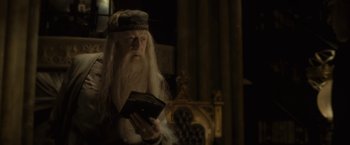 Movie still from “Harry Potter and the Half-Blood Prince” (2009), directed by David Yates – Albus dumbledore holding a book; Medium shot, Low angle