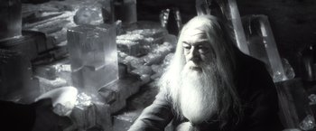 Movie still from “Harry Potter and the Half-Blood Prince” (2009), directed by David Yates – An old man with long white hair and a long white beard; Close Up shot, High angle