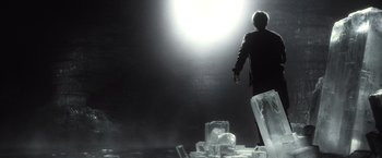 Movie still from “Harry Potter and the Half-Blood Prince” (2009), directed by David Yates – A man standing in front of a bunch of ice cubes; Wide shot, Low angle