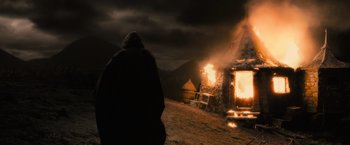 Movie still from “Harry Potter and the Half-Blood Prince” (2009), directed by David Yates – A person standing in front of a fire; Wide shot, Low angle