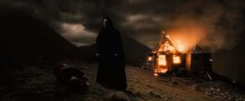 Movie still from “Harry Potter and the Half-Blood Prince” (2009), directed by David Yates – A man standing in front of a burning house; Extreme Wide shot, Low angle