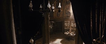 Movie still from “Harry Potter and the Half-Blood Prince” (2009), directed by David Yates – A room filled with furniture and lighting in a room; Wide shot, High angle