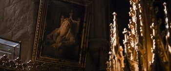 Movie still from “Harry Potter and the Half-Blood Prince” (2009), directed by David Yates – An old painting of a man with a beard and a crown; Medium shot, Low angle