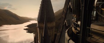 Movie still from “Harry Potter and the Half-Blood Prince” (2009), directed by David Yates – A view of hogwarts castle from the top of a building; Extreme Wide shot, Low angle