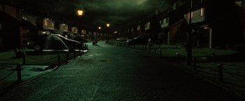 Movie still from “Harry Potter and the Order of the Phoenix” (2007), directed by David Yates – A dark street with a lot of cars parked on the side of the street; Extreme Wide shot, High angle