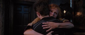 Movie still from “Harry Potter and the Order of the Phoenix” (2007), directed by David Yates – A woman is hugging a young man in a room; Medium shot, Low angle