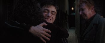 Movie still from “Harry Potter and the Order of the Phoenix” (2007), directed by David Yates – A man and a woman hugging each other in the dark; Close Up shot, Over the shoulder angle