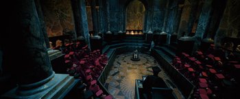 Movie still from “Harry Potter and the Order of the Phoenix” (2007), directed by David Yates – A group of people sitting in a room with a fireplace; Extreme Wide shot, High angle