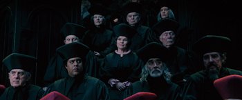 Movie still from “Harry Potter and the Order of the Phoenix” (2007), directed by David Yates – A group of men and women wearing black robes and hats; Medium shot, High angle