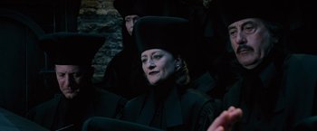 Movie still from “Harry Potter and the Order of the Phoenix” (2007), directed by David Yates – A woman wearing a black hat and a black robe; Close Up shot, High angle