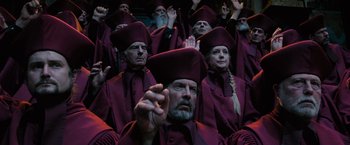 Movie still from “Harry Potter and the Order of the Phoenix” (2007), directed by David Yates – A group of people dressed up in purple robes and hats; Medium shot, High angle