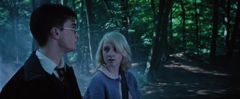 Movie still from “Harry Potter and the Order of the Phoenix” (2007), directed by David Yates – A young girl and a young man in a wooded area; Close Up shot, Over the shoulder angle