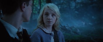 Movie still from “Harry Potter and the Order of the Phoenix” (2007), directed by David Yates – A young blonde haired girl in a blue sweater looking at the camera; Close Up shot, Over the shoulder angle