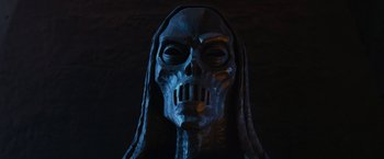 Movie still from “Harry Potter and the Order of the Phoenix” (2007), directed by David Yates – A statue of a skeleton with long hair and a skull face; Close Up shot, Low angle