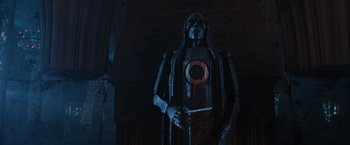 Movie still from “Harry Potter and the Order of the Phoenix” (2007), directed by David Yates – A statue of a skeleton holding a knife in a dark room; Medium shot, Low angle