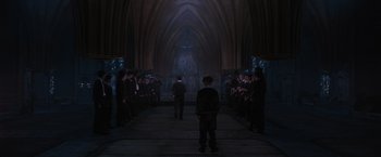 Movie still from “Harry Potter and the Order of the Phoenix” (2007), directed by David Yates – A group of people standing in front of an archway; Extreme Wide shot, High angle