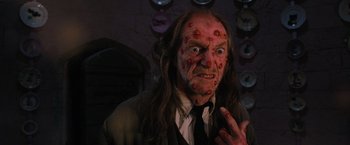 Movie still from “Harry Potter and the Order of the Phoenix” (2007), directed by David Yates – An old man with a red face and long hair; Close Up shot, Low angle