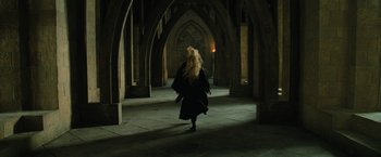 Movie still from “Harry Potter and the Order of the Phoenix” (2007), directed by David Yates – A woman in a black robe walking in a dark room; Wide shot, Low angle