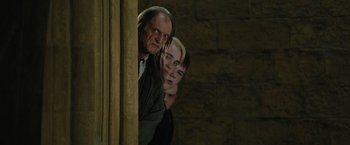 Movie still from “Harry Potter and the Order of the Phoenix” (2007), directed by David Yates – A group of people standing next to each other in a room; Medium shot, Low angle