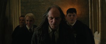 Movie still from “Harry Potter and the Order of the Phoenix” (2007), directed by David Yates – A group of people standing next to each other in a room; Medium shot, Low angle