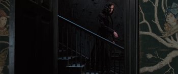 Movie still from “Harry Potter and the Order of the Phoenix” (2007), directed by David Yates – A man walking up a set of stairs in the dark; Wide shot, Low angle