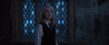 Movie still from “Harry Potter and the Order of the Phoenix” (2007), directed by David Yates – A young girl in front of a stained - glass window; Medium shot, Low angle